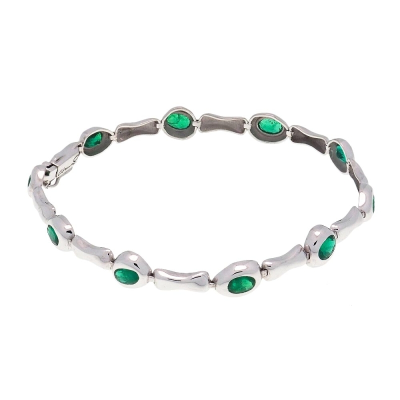 Pulsera oval de oro blanco y esmeraldas Pulsera articulada realizada en oro blanco de 18k con forma de pequeños óvalos que cada